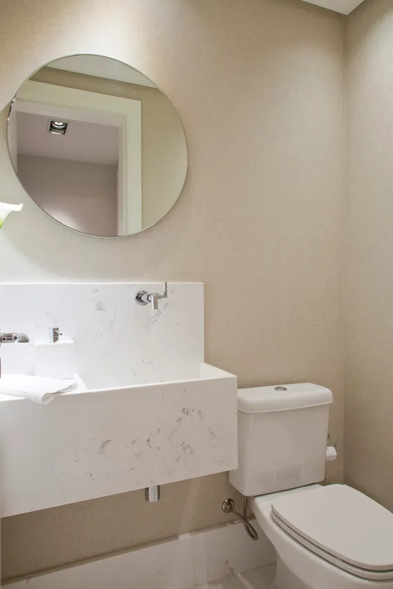 Lavabo clean com bancada de mármore suspensa e espelho redondo